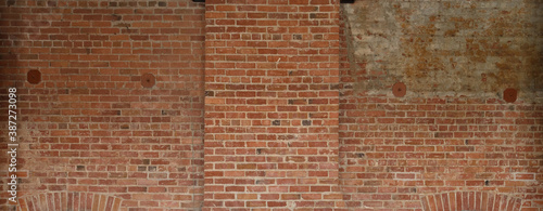 red brick wall background showing grungy texture and patchwork