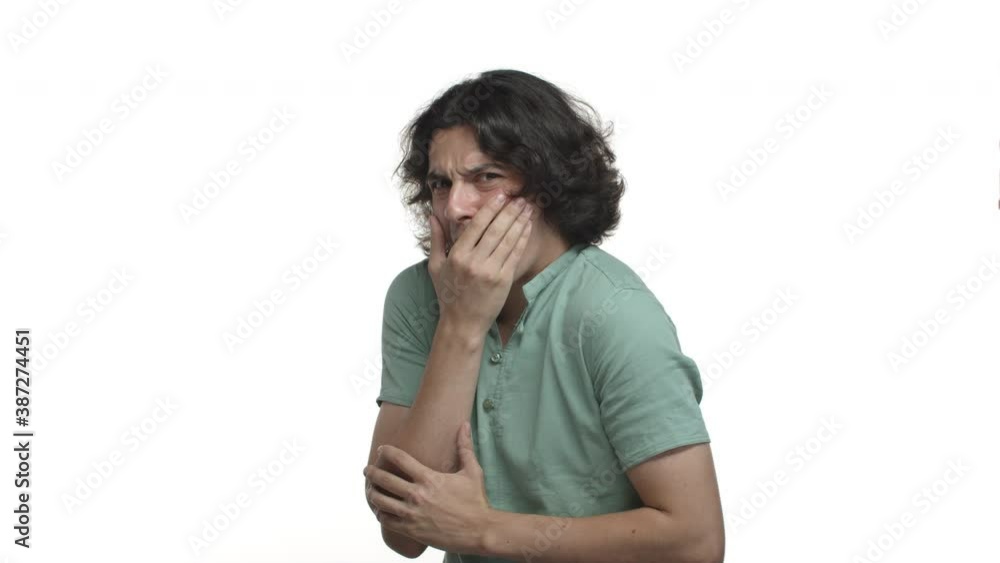Video of embarrassed young man in green shirt, gasping and freak out from something disgusting, standing reluctant over white background Video of embarrassed young man in green shirt, gasping and freak out from something disgusting, standing reluctant over white background
