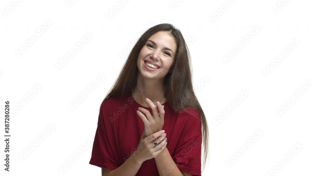 Beautiful smiling woman in red t-shirt laughing and looking grateful, thanking for something, standing over white background Beautiful smiling woman in red t-shirt laughing and looking grateful, thanking for something, standing over white background