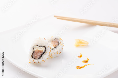 urakami style sushi roll on white plate and white background