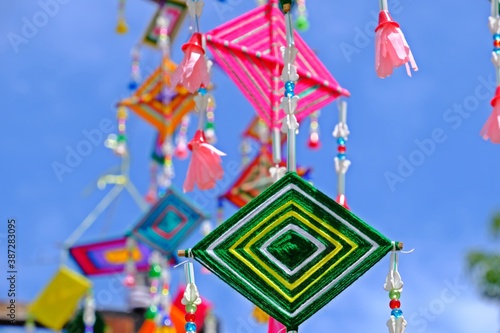 Colorful spider web flag of Thai local traditional Buddhist belief merit old style for protect is widespread decorate flags in religion events in the Northeast of Thailand.