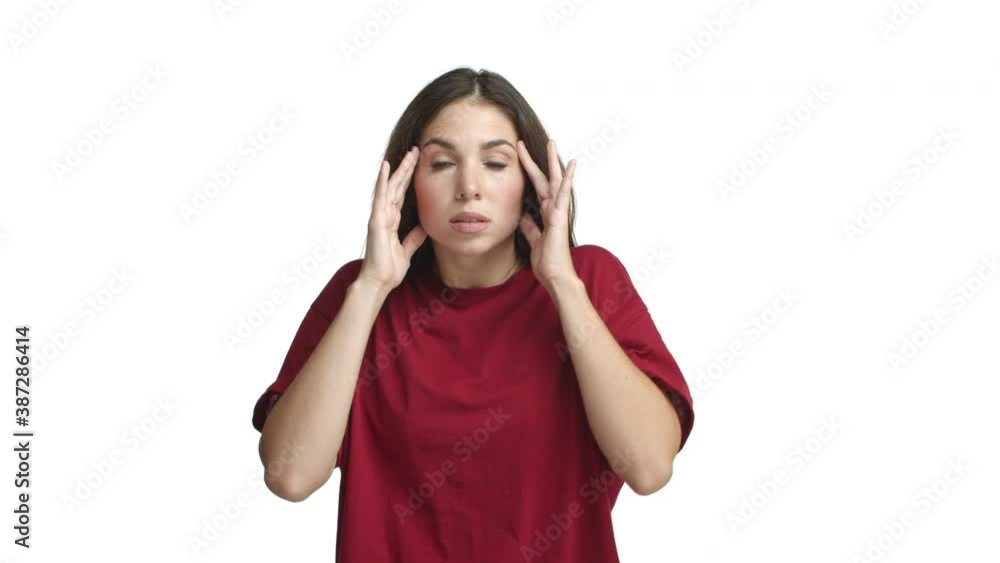 Young attractive woman in red t-shirt looking ambushed and scared, gasping and screaming horrified, standing frightened against white background Young attractive woman in red t-shirt looking ambushed and scared, gasping and screaming horrified, standing frightened against white background