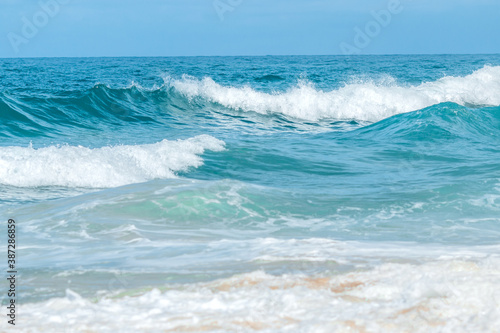 Travel vacation background, at summer beach, with sunny sky, Water wave splash on blue sea background., at summer beach, with sunny sky, Water wave splash on blue sea background.