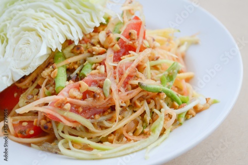 spicy papaya salad on wood floor - Thailand healthy food