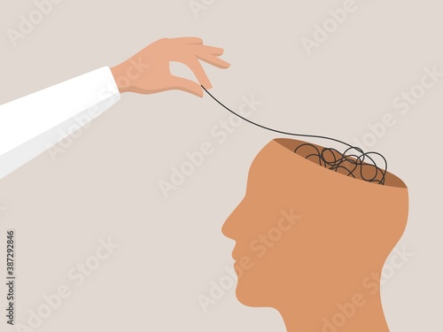 Psychotherapy or Psychology concept. Helping hand unravels the tangle of thoughts of a head with mental disorder, anxiety and confusion mind.