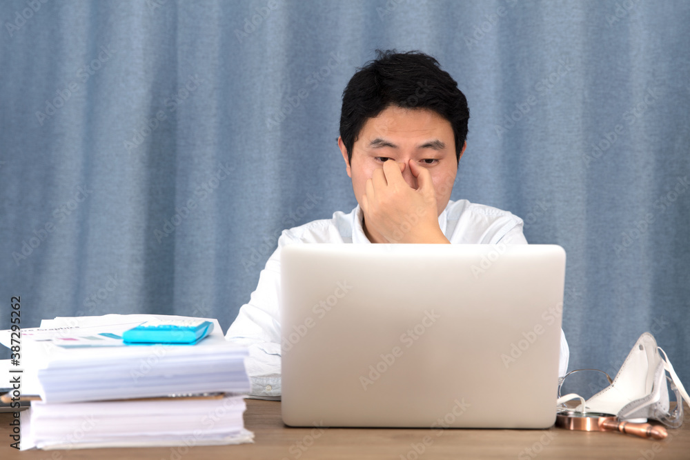 Tired young office worker Tired young office worker