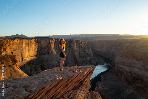 Carefree woman on Grand canyon. Canyon american national park. Female tourist enjoying view of Horseshoe bend, Arizona. Enjoy freedom and explorer concept.