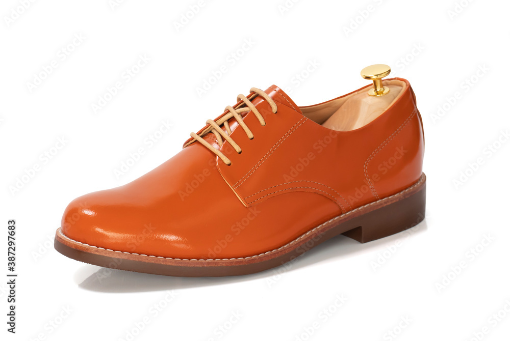 Men fashion orange shoes leather with shoe tree (shape supporter) isolated on white background. Clipping path Men fashion orange shoes leather with shoe tree (shape supporter) isolated on white background. Clipping path