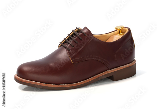 Men fashion brown shoes leather with shoe tree (shape supporter) isolated on white background. Clipping path