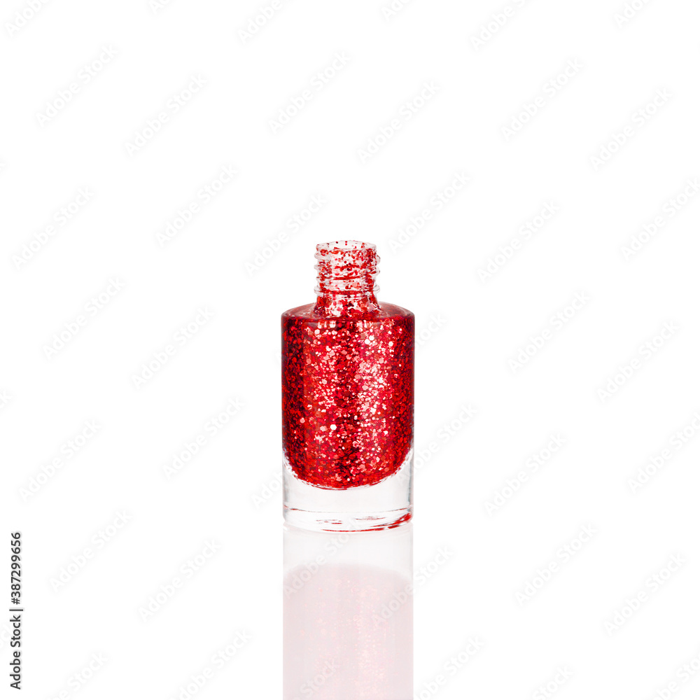 Red glittering nail polish in glass bottle on white background isolated closeup, opened pink sequin varnish, bright shiny scarlet lacquer, sparkling enamel, beautiful shimmer gel, cosmetic accessory Red glittering nail polish in glass bottle on white background isolated closeup, opened pink sequin varnish, bright shiny scarlet lacquer, sparkling enamel, beautiful shimmer gel, cosmetic accessory