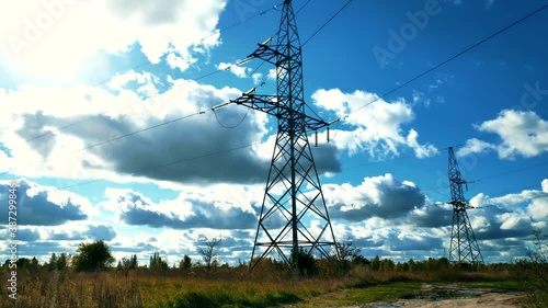 Power Lines And Blue Sky Time Lapse.High Voltage Electricity Transmission Pylon.Power Lines Supply With Wire.High Voltage Electric Tower With Insulators.Electricity Transportation Industry Energetics
