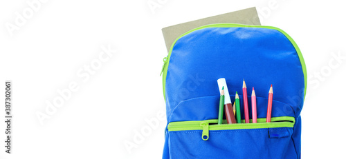 School supplies for school children In a blue backpack on a white background. © BNMK0819