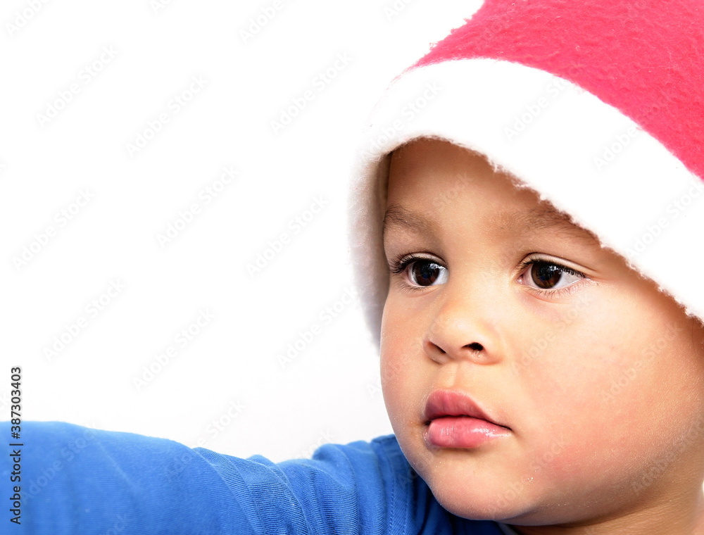little boy with Christmas hat on his head with white background stock photo little boy with Christmas hat on his head with white background stock photo