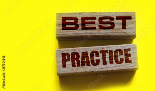 best practice words on wooden blocks on yellow. Business and healthcare concept photo