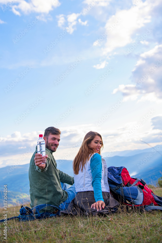 Young couple taking a break on a hike.