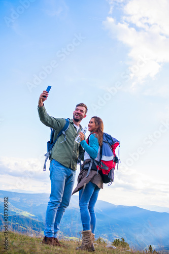 Happy Couple On A Hike Taking A Selfie