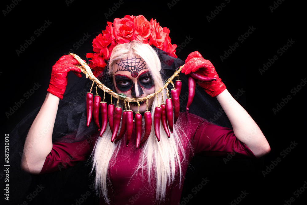 Young woman with peppers and sugar skull make-up for Halloween