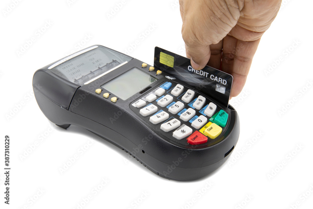 Hand swiping credit card on credit card machine isolated on white background Hand swiping credit card on credit card machine isolated on white background