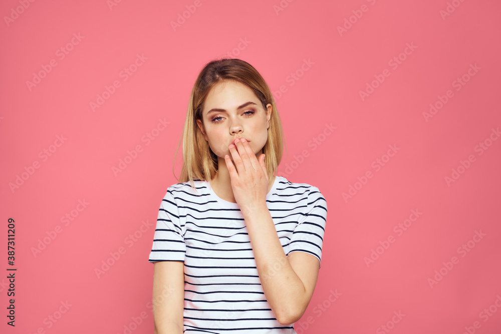 Woman in striped t-shirt emotions studio cropped view lifestyle pink isolated background Woman in striped t-shirt emotions studio cropped view lifestyle pink isolated background