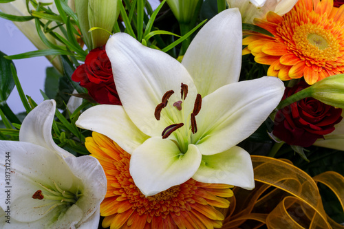 Fototapeta Naklejka Na Ścianę i Meble -  A beautiful bouquet of white lilies and orange gerberas