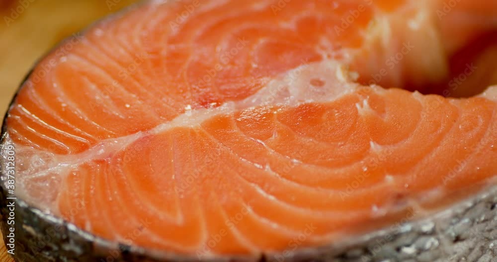 Raw fresh salmon steak slowly rotates. Raw fresh salmon steak slowly rotates.
