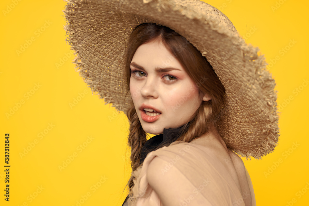 Portrait woman in straw hat on yellow background cropped view of summer dress model pigtails romance Portrait woman in straw hat on yellow background cropped view of summer dress model pigtails romance