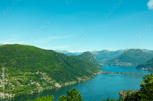 Aerail View over Lugano with Alpine Lake and Mountain in a Sunny Day in Ticino, Switzerland.