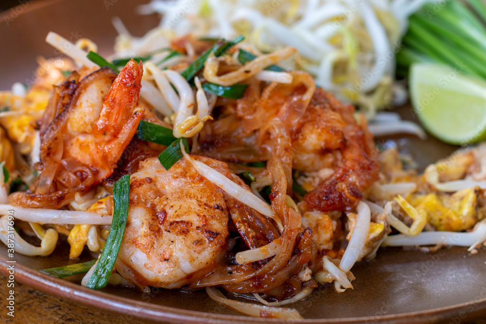 Pad Thai, Traditional stir-fried rice noodle dish commonly served as a street food and at most restaurants in Thailand as part of the country's cuisine. Stir fry noodles with sweet savoury sour sauce.
