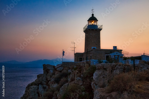 Lighthouse on the coast on sunset, Greece coastline