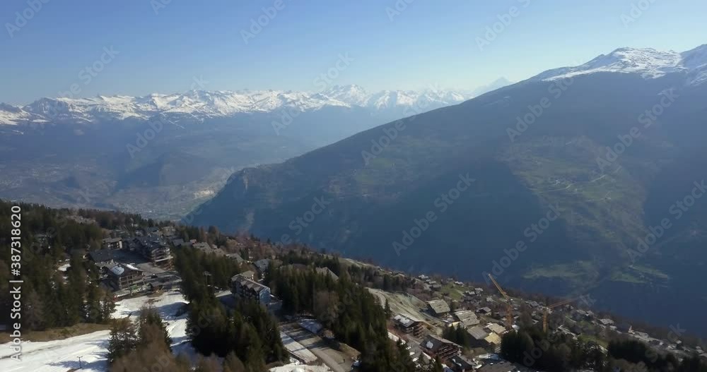 Stunning aerial view of ski village and mountain range in Swiss Alps Stunning aerial view of ski village and mountain range in Swiss Alps