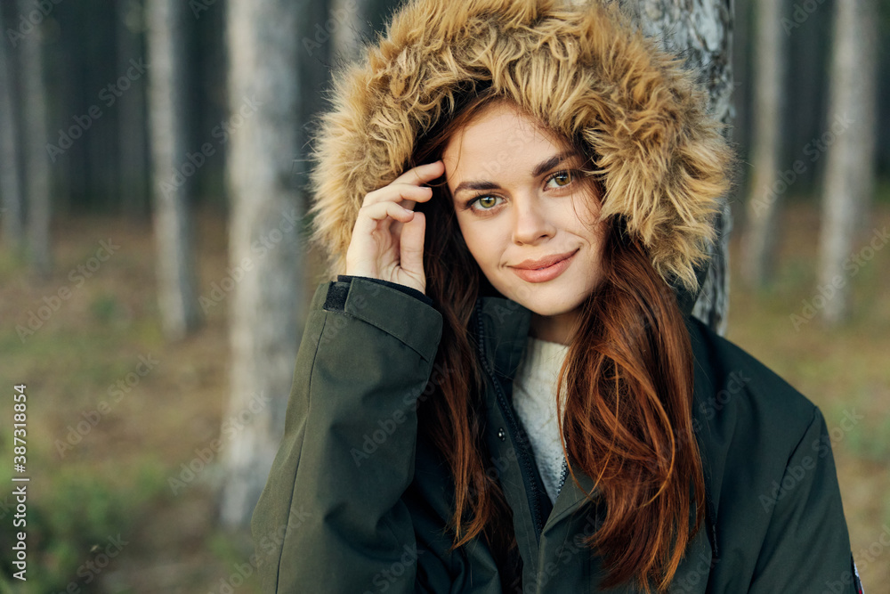 woman in a jacket with a hood near a tree outdoors tourism fresh air woman in a jacket with a hood near a tree outdoors tourism fresh air