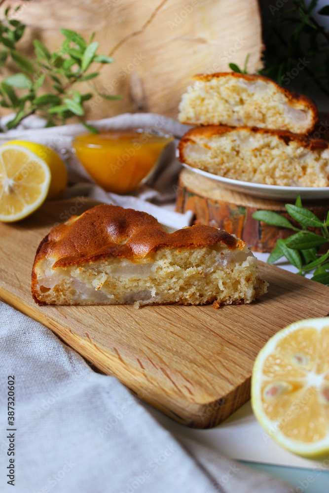 Honey Apple pie with a crust on a wooden Board with lemon