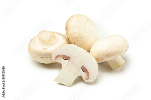 Four raw champignons isolated on white background