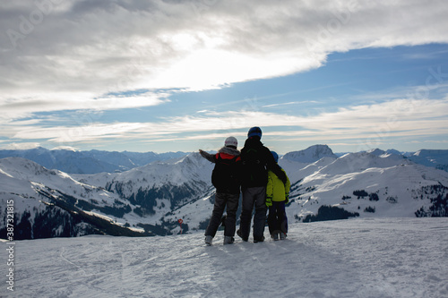 Family, skiing in winter ski resort on a sunny day, enjoying nature
