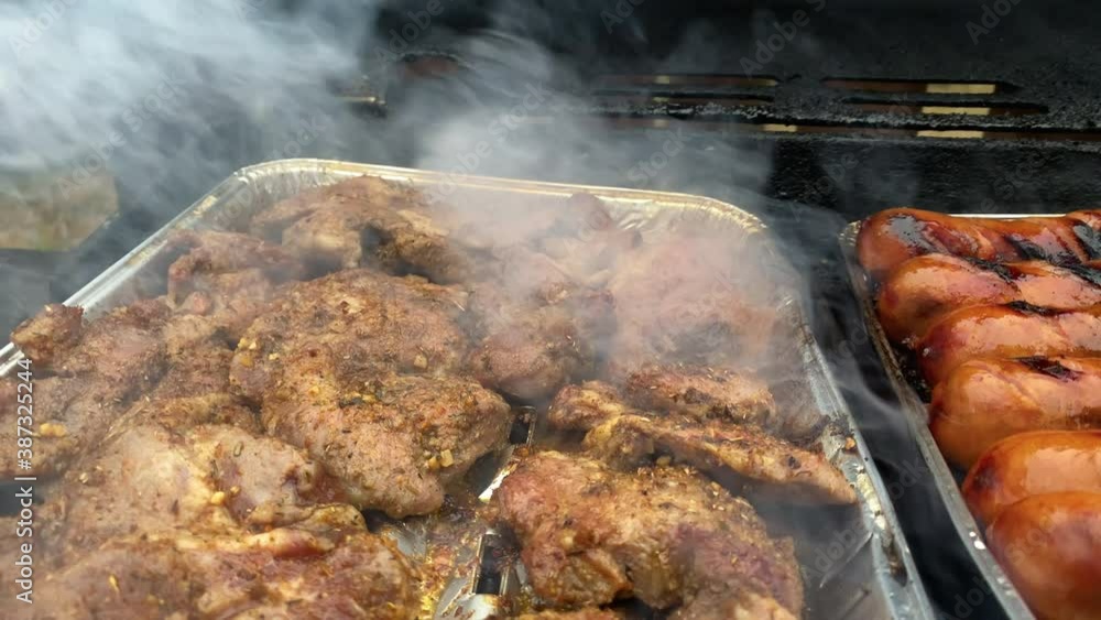 Smoky delicious meat pork and sausage cooking Smoky delicious meat pork and sausage cooking