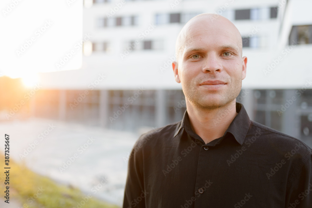 Portrait of a young handsome man with beard looking in camera at the sunset outdoors. High quality photo Portrait of a young handsome man with beard looking in camera at the sunset outdoors. High quality photo