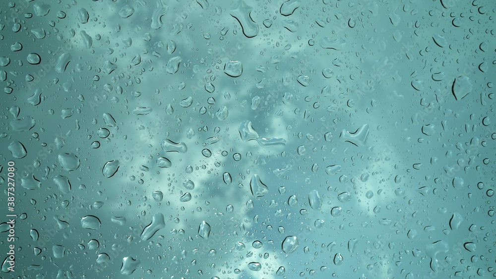 Rain droplets falling on the glass, a rainy day in autumn Rain droplets falling on the glass, a rainy day in autumn