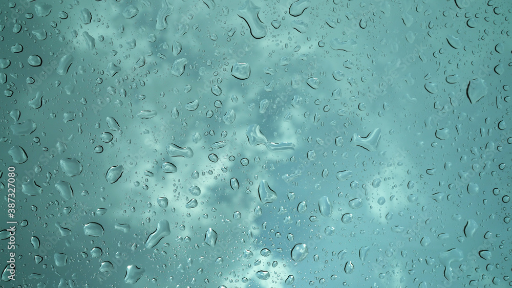 Rain droplets falling on the glass, a rainy day in autumn