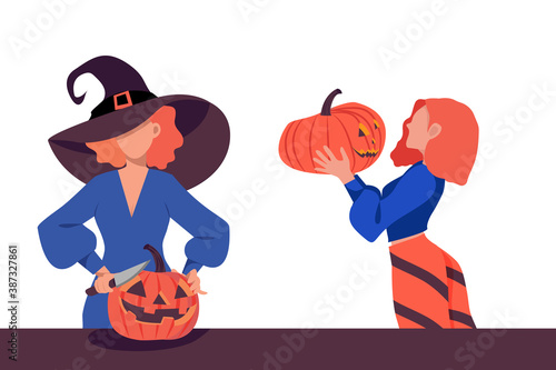 Two girls are holding a pumpkin lantern for Halloween. A girl with a knife cuts a lantern from a pumpkin.