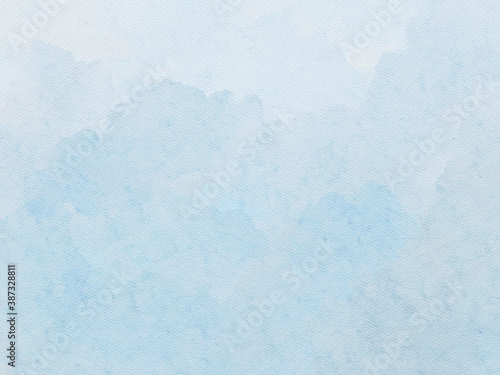 Hand painted subtle blue watercolor background with paper texture