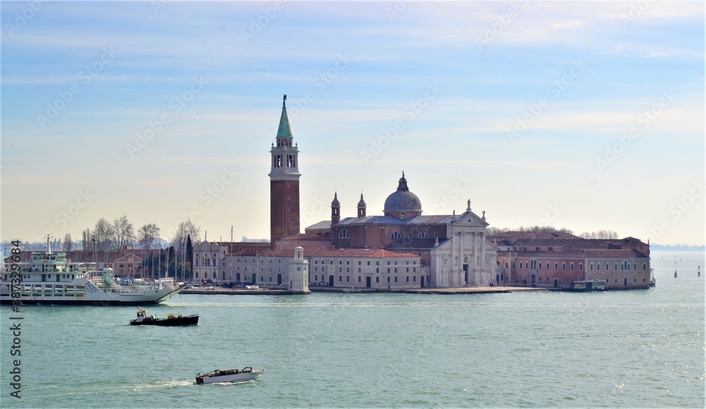 San Giorgio Maggiore (church), Venice Italy. San Giorgio in Venice (Venedig) during sunny day and turquoise sea. White and blue sky. San Giorgio Maggiore (church), Venice Italy. San Giorgio in Venice (Venedig) during sunny day and turquoise sea. White and blue sky.