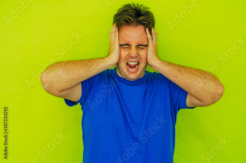 Screaming Young Flabby Redhead Guy Isolated Shouting Angry in Green Background