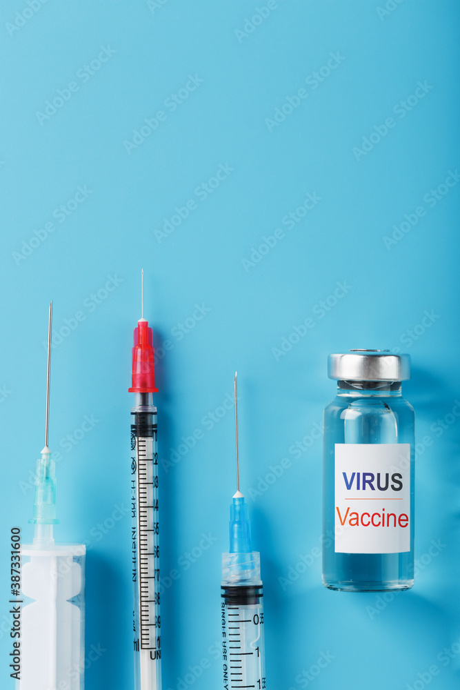 Syringes and ampoule with the vaccine against the Virus from diseases on a blue background. Syringes and ampoule with the vaccine against the Virus from diseases on a blue background.