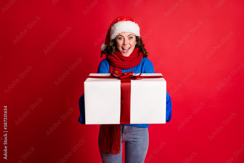 Portrait of her she nice attractive cheerful cheery girl wearing festal cloth holding in hands giving delivering you big large giftbox isolated bright vivid shine vibrant red color background Portrait of her she nice attractive cheerful cheery girl wearing festal cloth holding in hands giving delivering you big large giftbox isolated bright vivid shine vibrant red color background