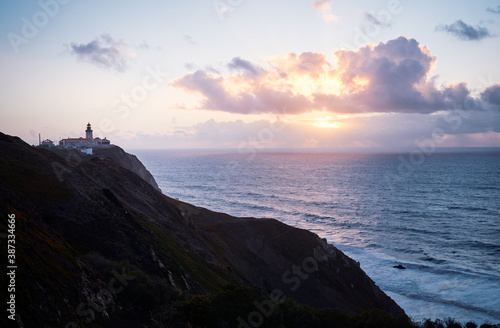 Famous lighthouse on Cabo da Roca, the western point of Europe. Beautiful sunset landscape with ocean shore.