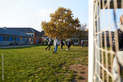 Kids playing soccer at school