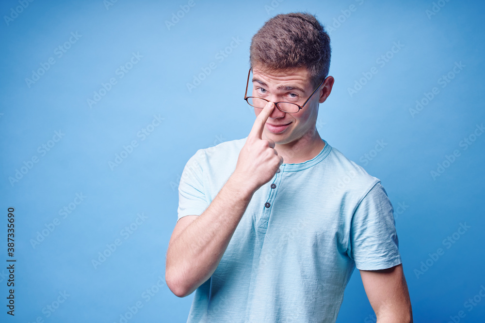 Studio portrait of happy handsome young man on blue background. Studio portrait of happy handsome young man on blue background.