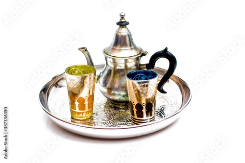 Group of teapot and glasses of oriental tea on a tray on white background