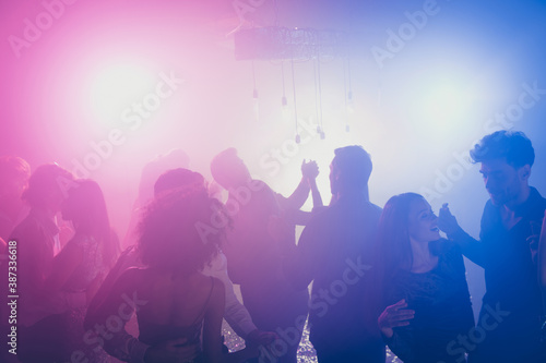 Photo of big group many people charming couple pair dance flirt neon bright pink spotlight modern club indoors