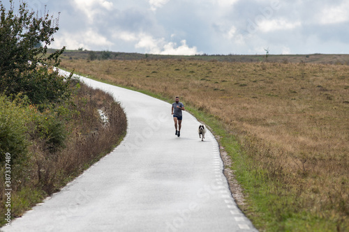 young man running on country road © Melinda Nagy